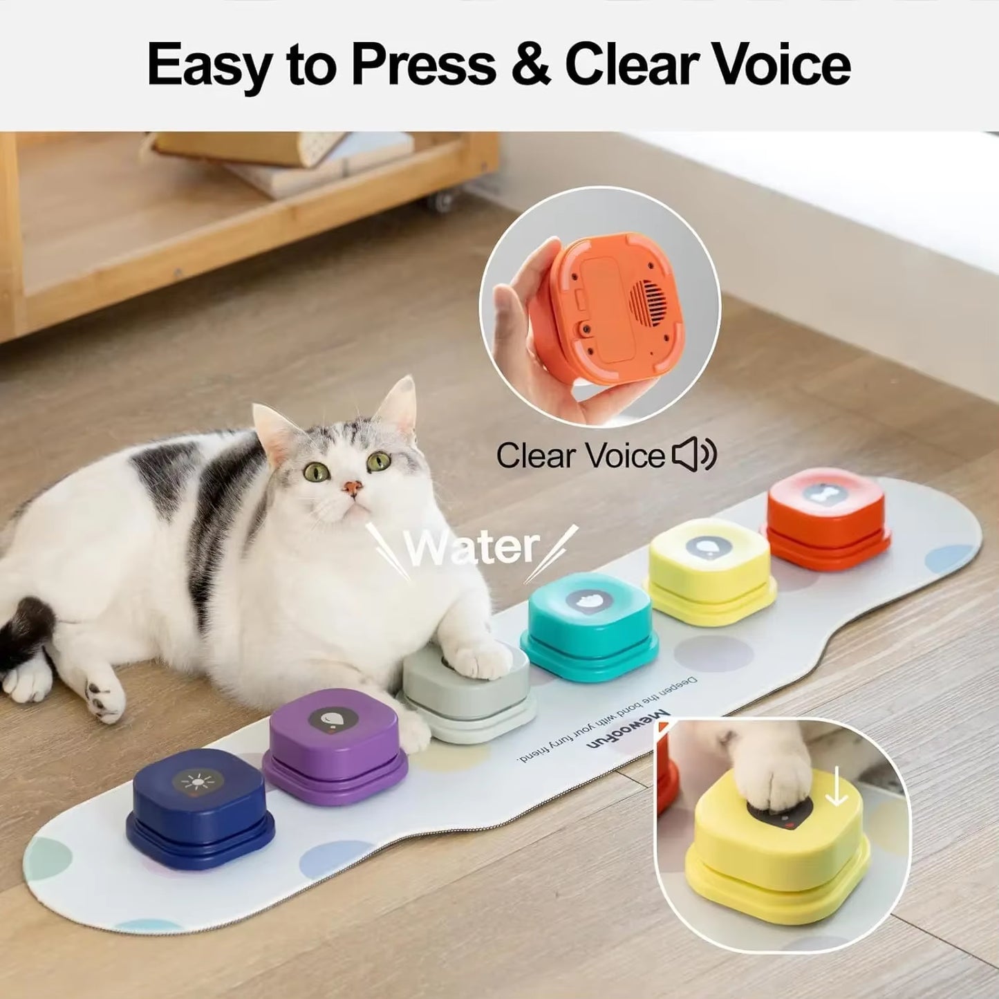 Four talking buttons in orange, yellow, cream, and navy arranged on the oval mat with a sticker sheet