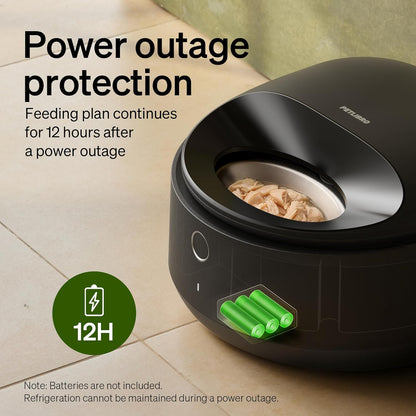 Black Polar automatic wet cat feeder positioned on a kitchen floor near a wall outlet