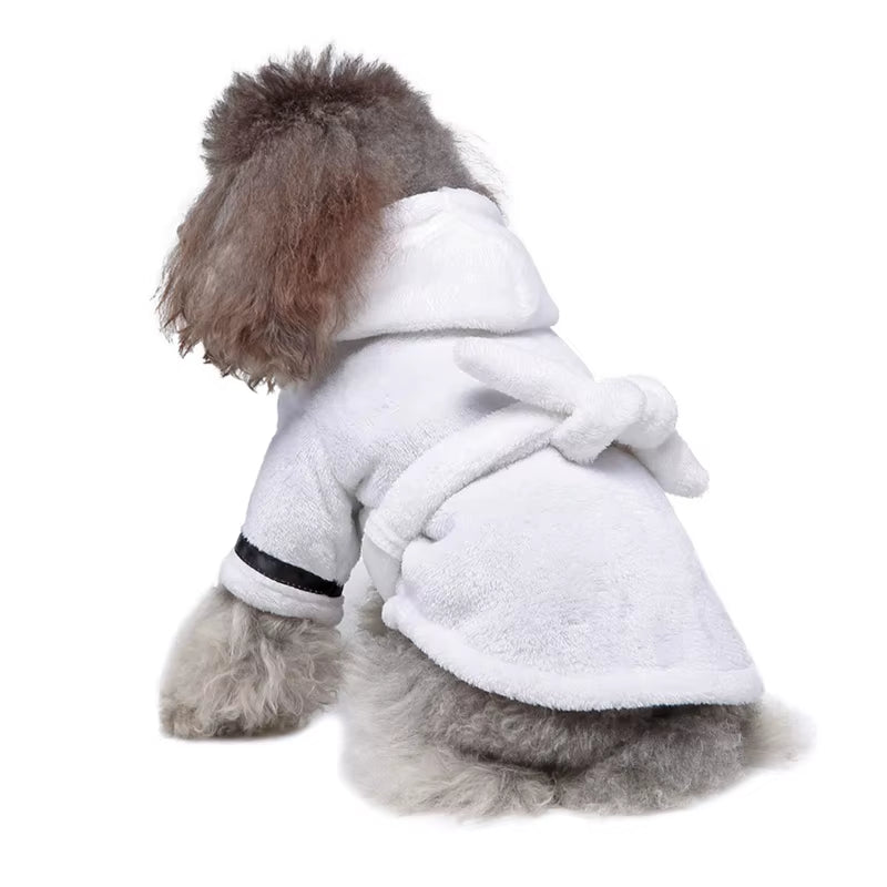 Brown plush hooded dog bathrobe laid flat with its belt tied in a bow at the waist