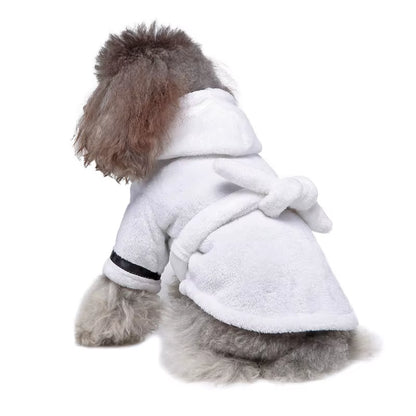 Brown plush hooded dog bathrobe laid flat with its belt tied in a bow at the waist