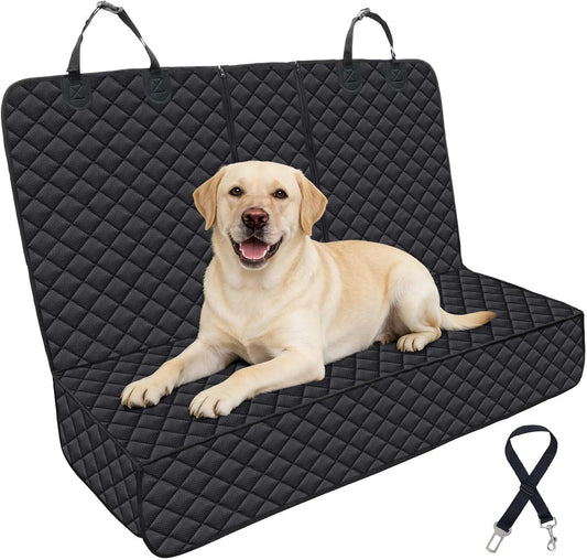 Yellow Labrador lying on a black quilted waterproof car seat cover with carry handles and a seatbelt tether