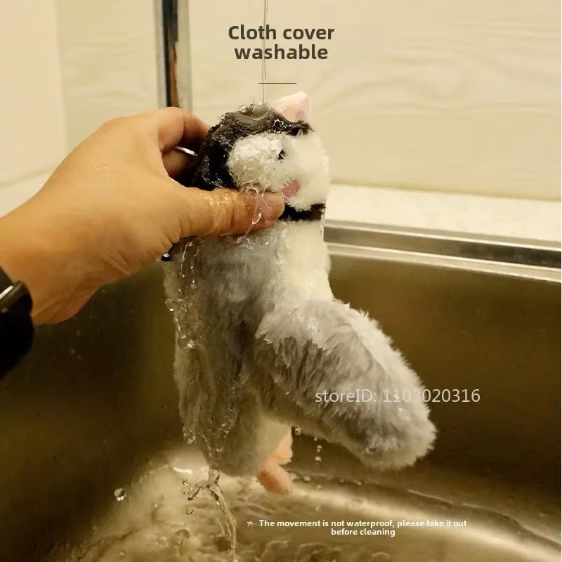 Hand rinsing the washable cloth cover of the FlutterChirp cat toy under a sink faucet before drying