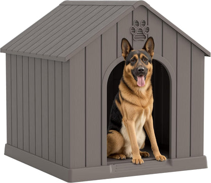 Grey plastic dog house shown outdoors in a backyard with a wood fence in the background