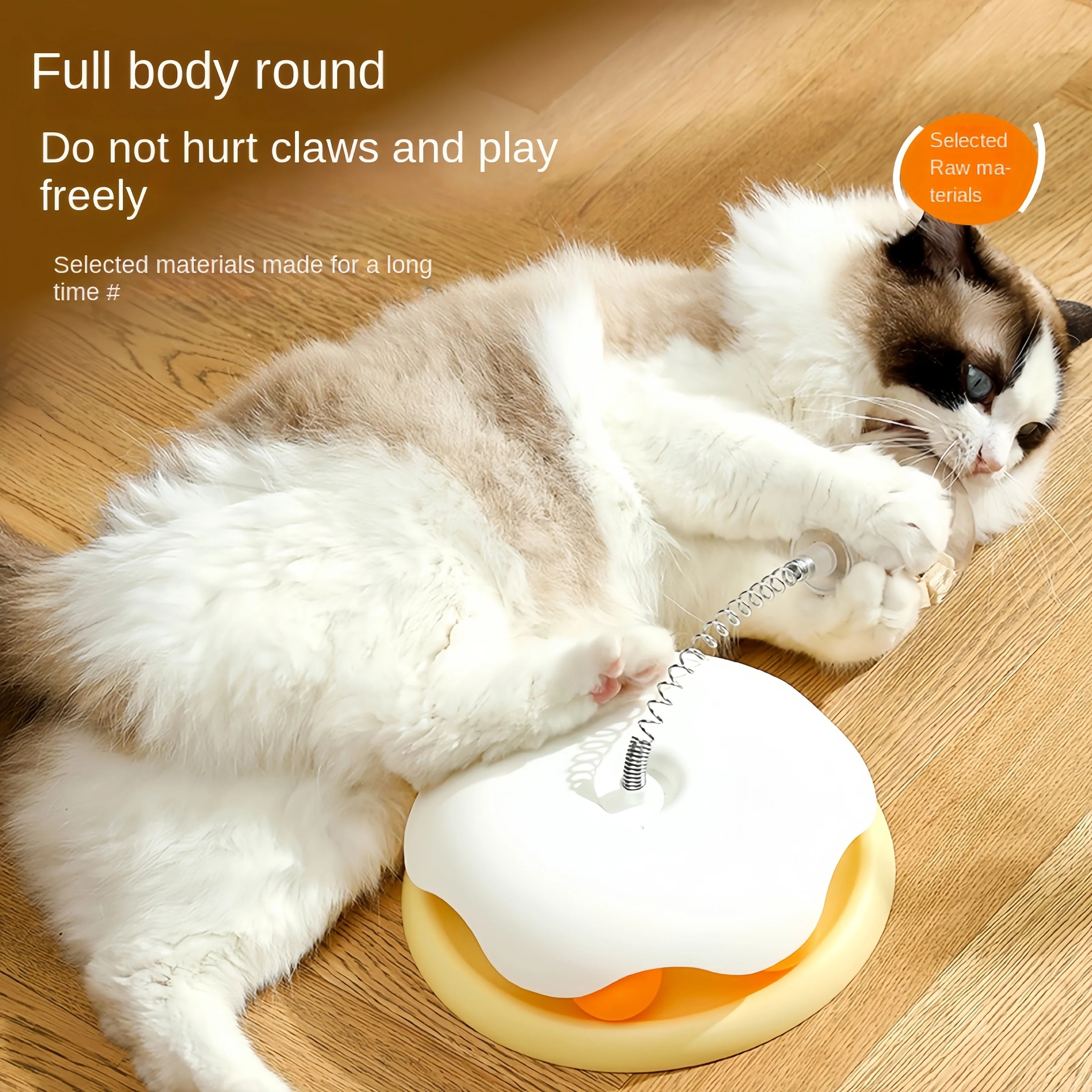 Cat pawing at the spring-mounted treat ball on top of a yellow and white puzzle toy base