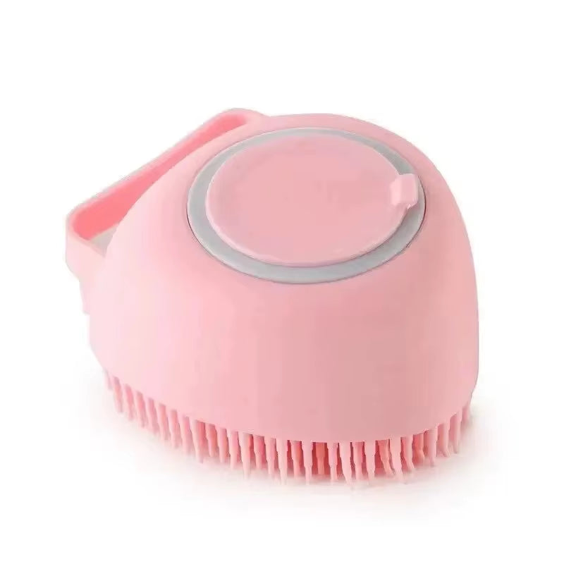 Pink silicone bath brush shown from the back highlighting its wrist strap and thumb release button