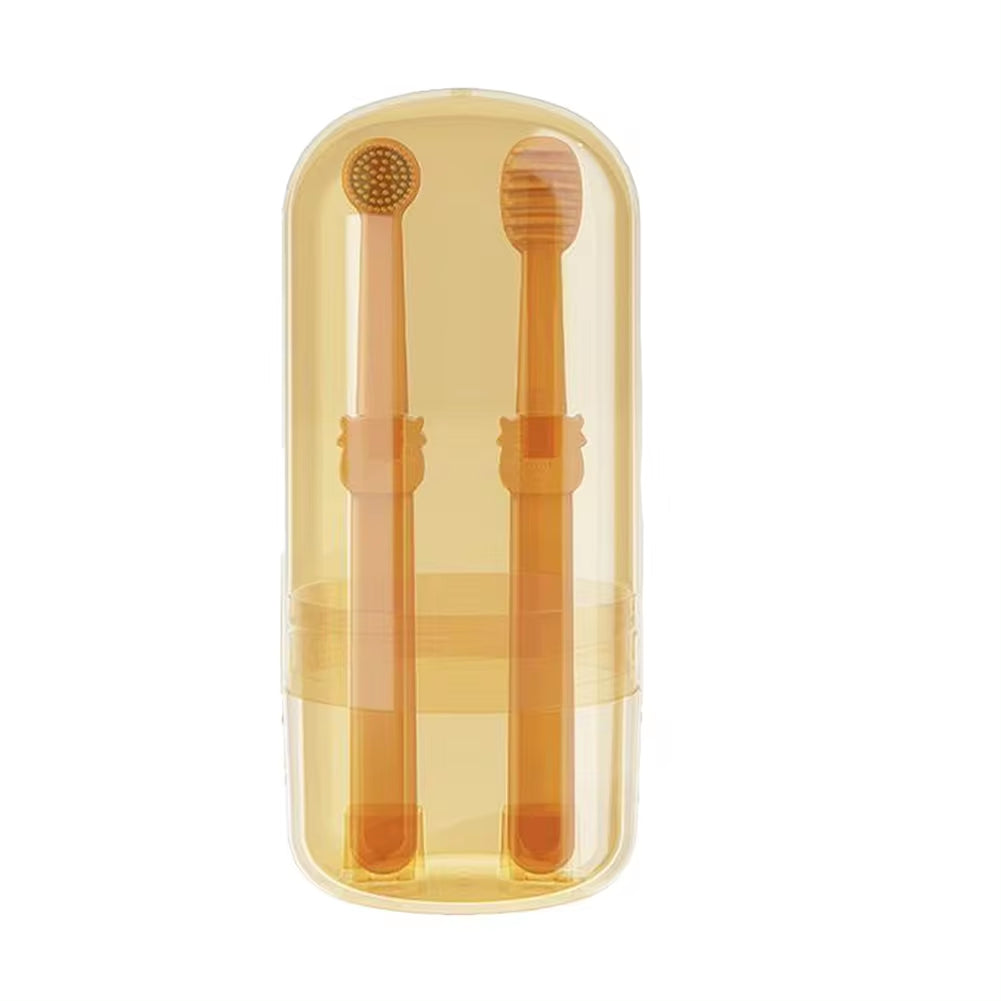 Two orange silicone toothbrushes standing upright in their clear plastic travel case