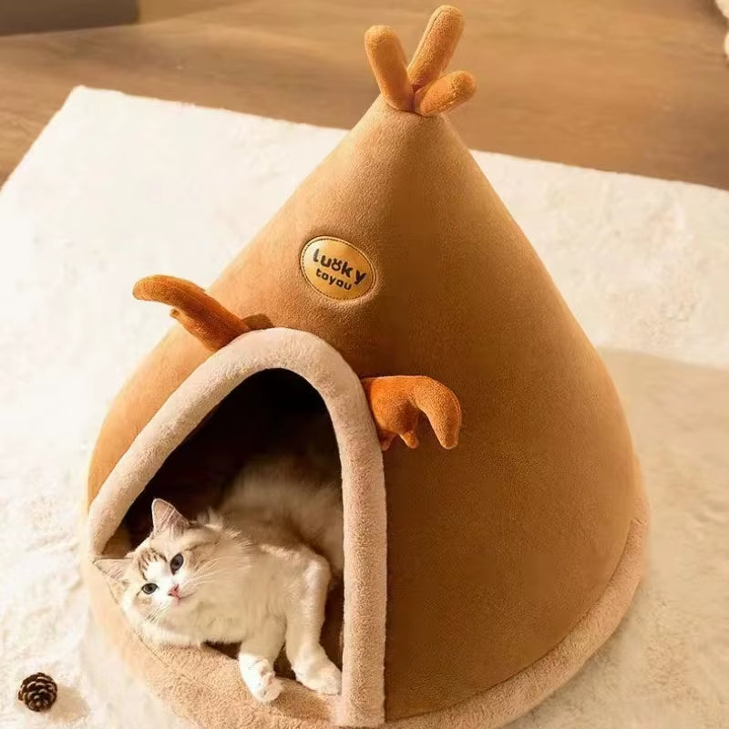 Cat curled up resting inside the tan teepee-shaped pet tent with plush antler decorations