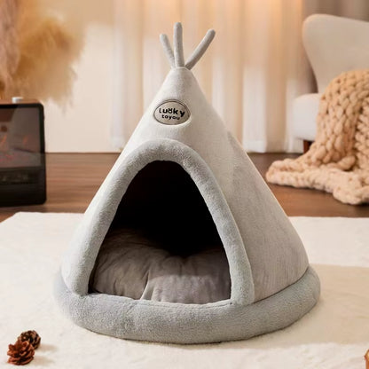 Cone-shaped pet tent shown next to a couch to illustrate typical placement in a home