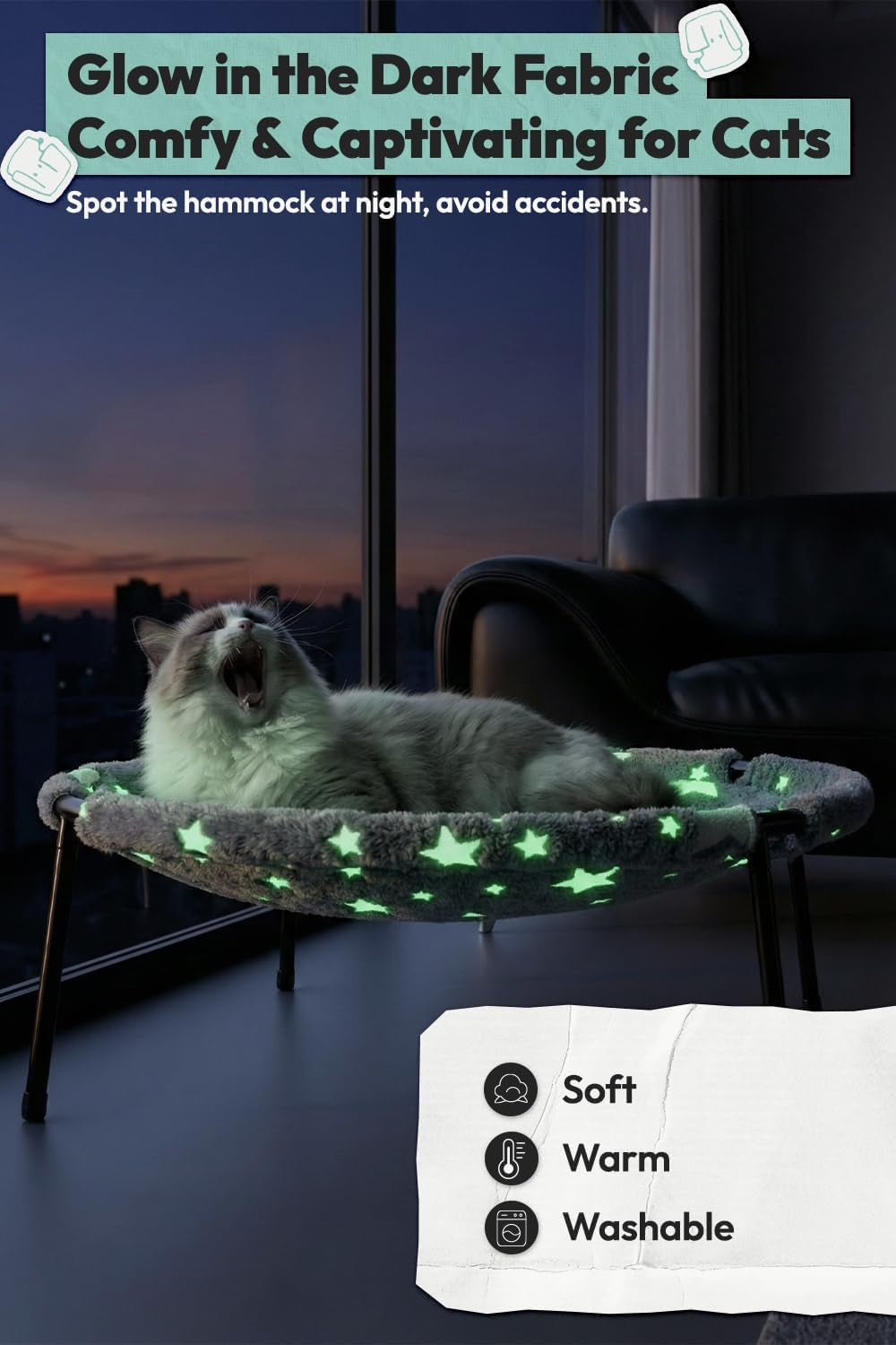 White cat yawning while lying in the elevated cat bed, its star pattern glowing green at night