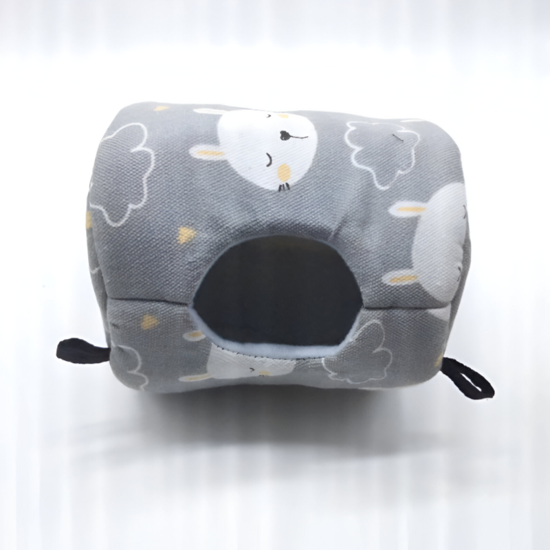 Gray canvas hammock bed printed with a sheep and cloud pattern showing its entrance hole