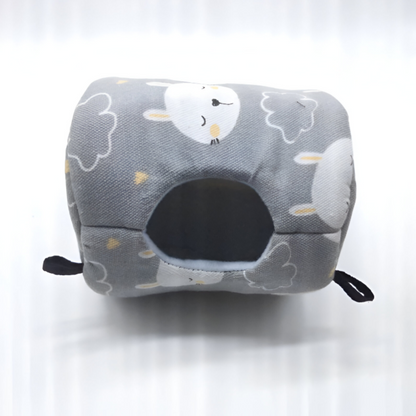 Gray canvas hammock bed printed with a sheep and cloud pattern showing its entrance hole